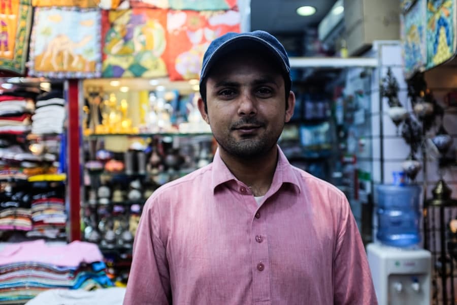 Shopkeeper behind the counter of his store