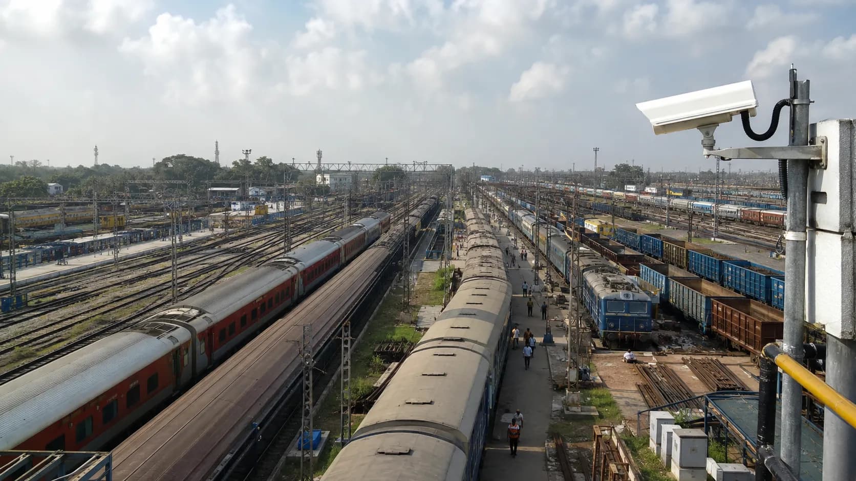 Aerial view of a railway yard with a CCTV camera pole covering multiple tracks
