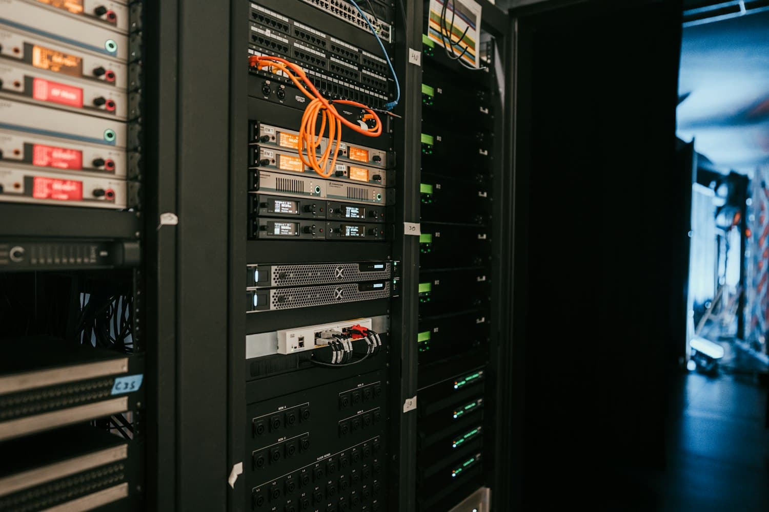 Rows of server and storage hardware in a dark data hall