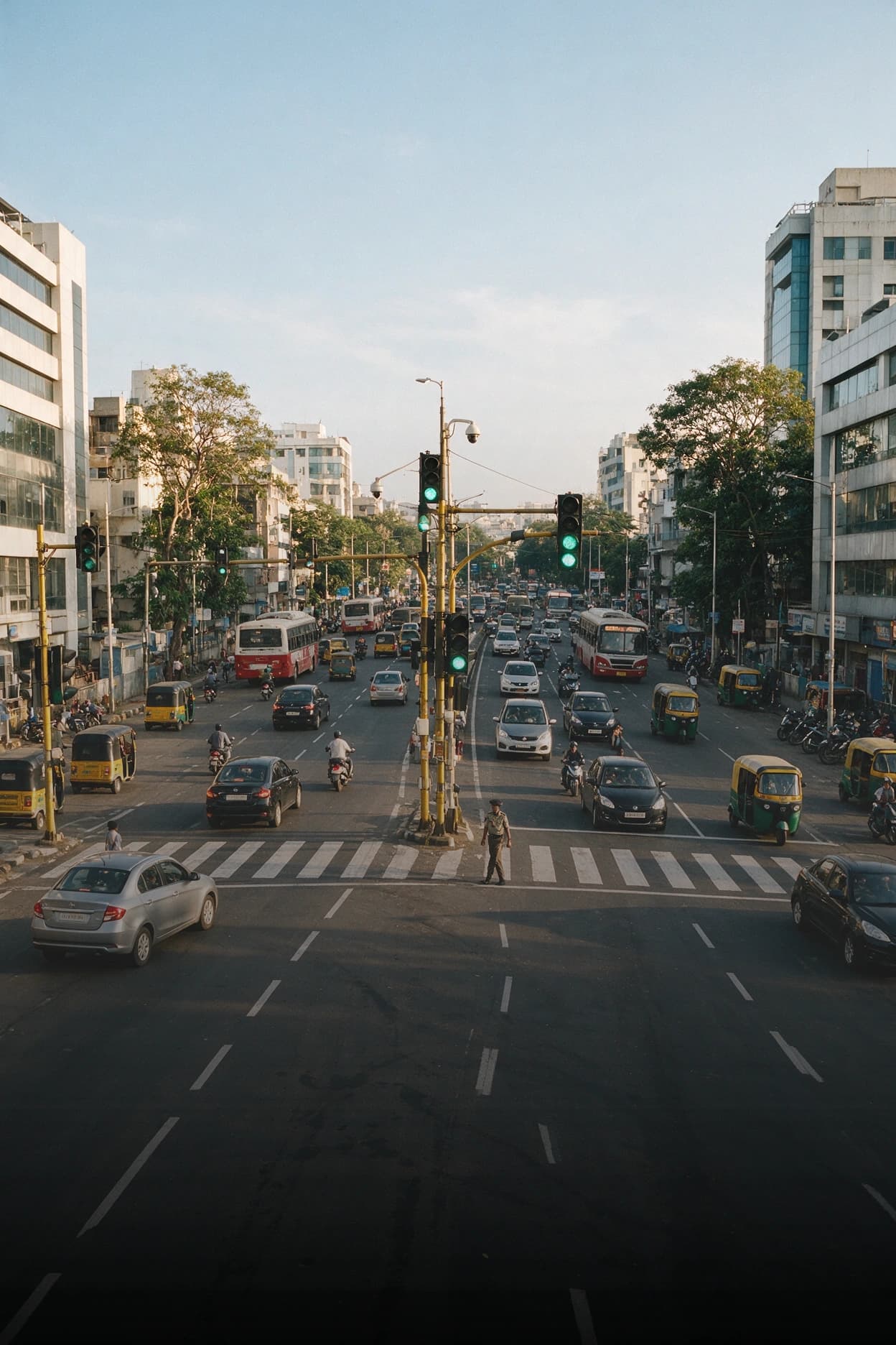 Smart City Traffic Camera Health Monitoring Busy city traffic intersection with a CCTV camera pole, part of a smart city surveillance network under health monitoring.