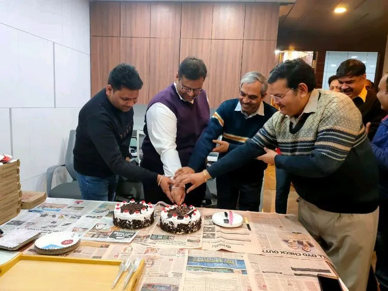 Cutting the cake at an office celebration