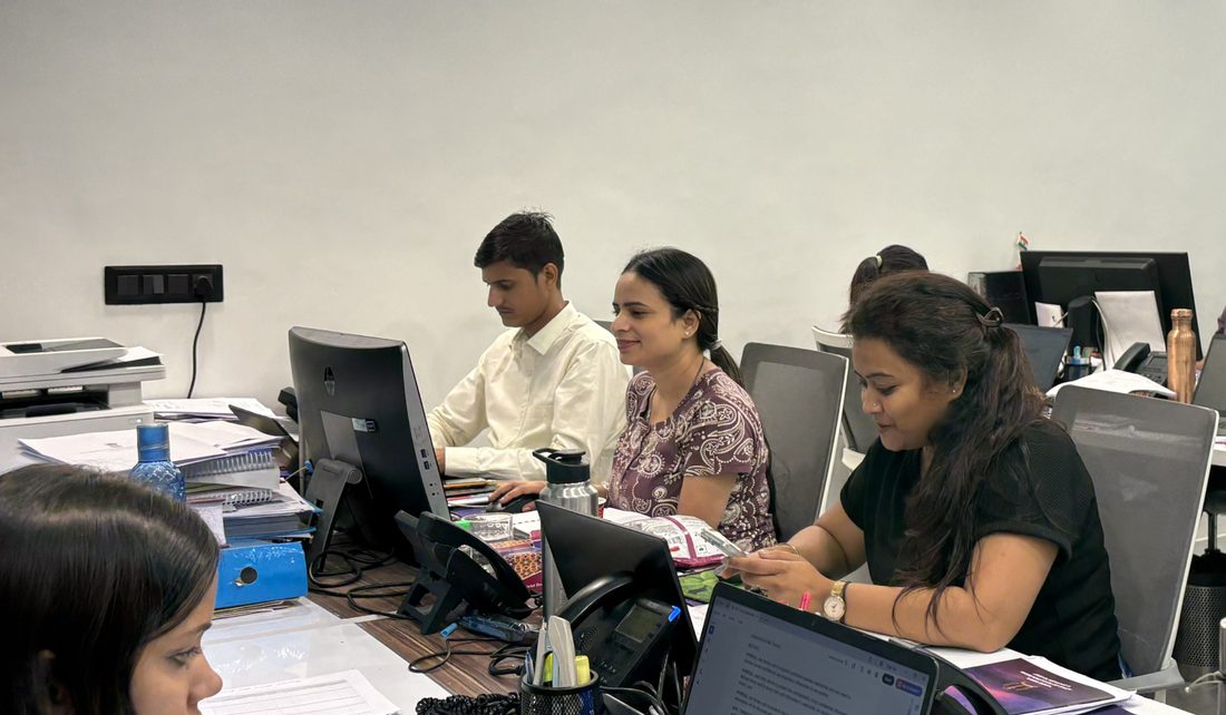 Employees at their workstations at the office desks
