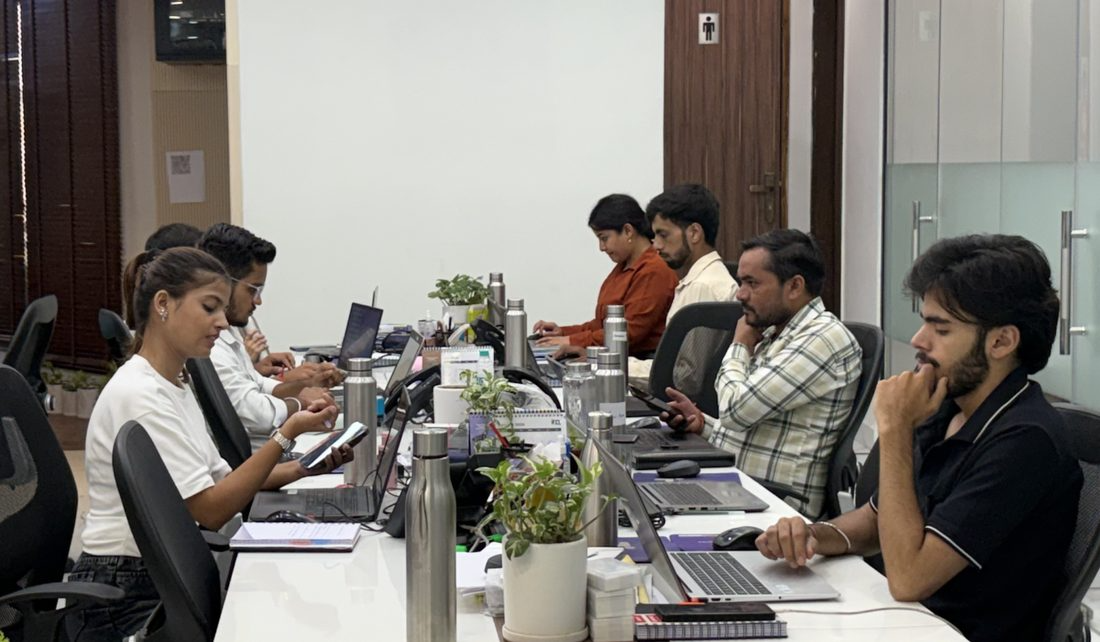 The team working along a long row of desks
