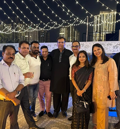 Transline team posing together at an evening rooftop celebration