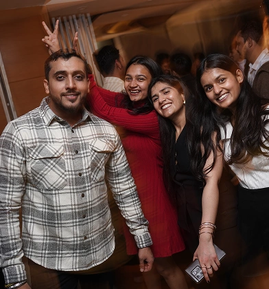 Colleagues laughing together at a team party
