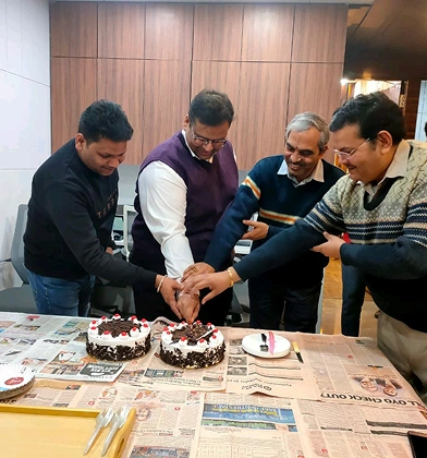 Transline team cutting celebration cakes together at the office