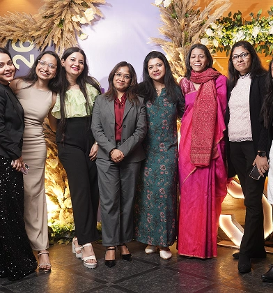 Women colleagues posing together at the annual celebration