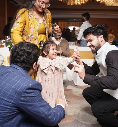 A child interacting playfully with the team at a celebration event