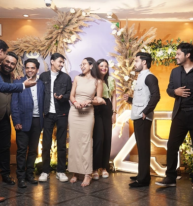 Team posing together at an anniversary celebration event