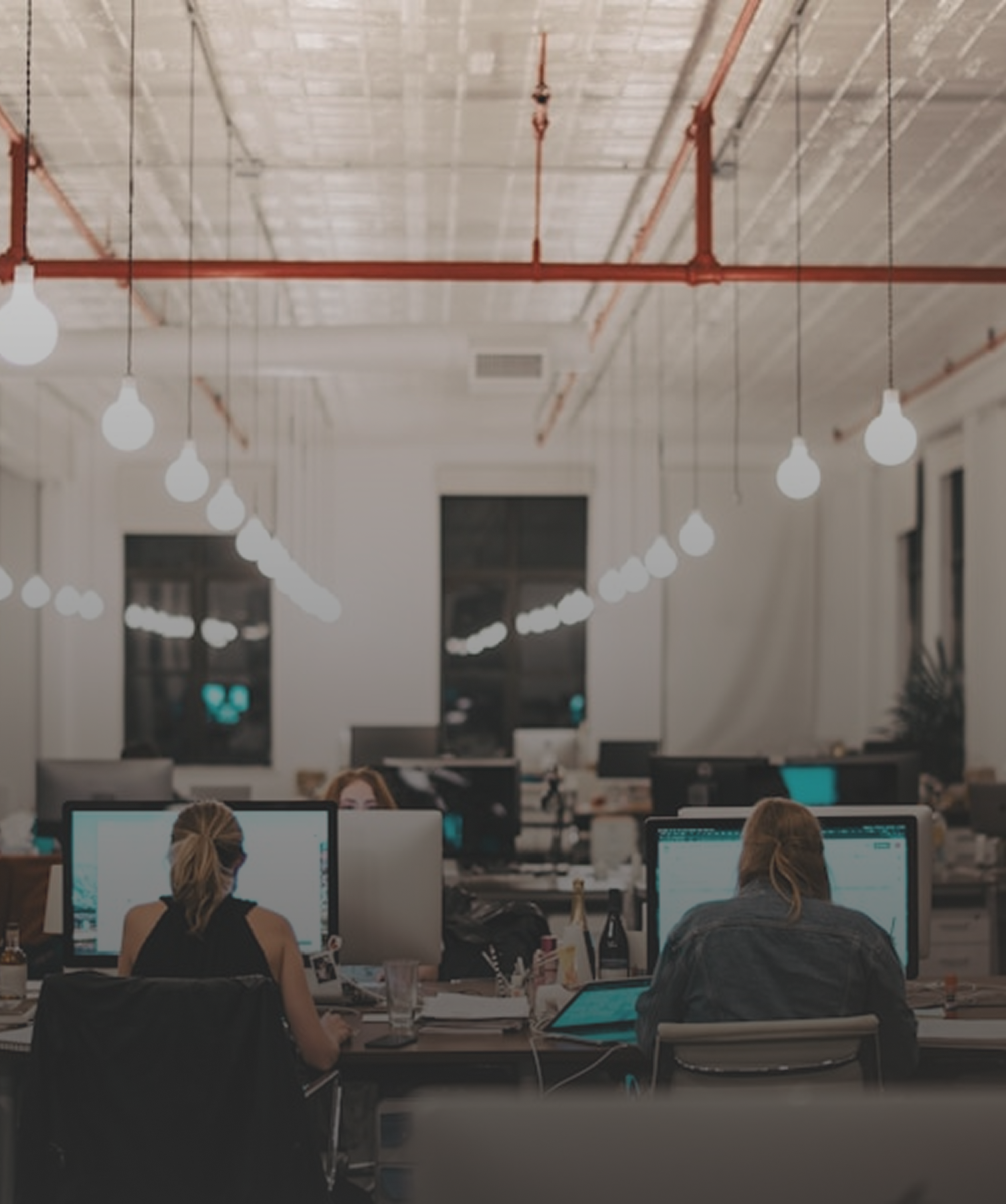 Corporate Office Security and Access Control Employees at computer desks in a corporate office, representing corporate security solutions